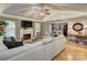 Spacious living room featuring hardwood floors, fireplace, neutral color scheme and access to the dining room at 6005 Bryant Ln, Waxhaw, NC 28173