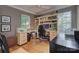 Functional home office with built-in shelves, hardwood floors, and natural lighting at 6005 Bryant Ln, Waxhaw, NC 28173
