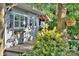Charming outbuilding with a covered porch that is surrounded by mature trees and shrubbery at 6005 Bryant Ln, Waxhaw, NC 28173