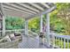 Relax on the covered porch with outdoor seating and lush landscaping views at 6005 Bryant Ln, Waxhaw, NC 28173