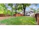 Expansive backyard featuring a lush green lawn, mature trees, and a privacy fence at 624 Oakland Ave, Charlotte, NC 28204