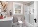 Modern bathroom includes a glass shower, unique mirror, and decorative tile flooring at 624 Oakland Ave, Charlotte, NC 28204