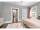 Neutral bedroom with an entryway to another room, natural light, and hard wood floors at 624 Oakland Ave, Charlotte, NC 28204