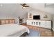 Large attic bedroom features wood floors, fireplace, ceiling fan and custom shelving at 624 Oakland Ave, Charlotte, NC 28204