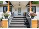 Inviting front porch with gray brick steps, fresh flowers, and cozy seating at 624 Oakland Ave, Charlotte, NC 28204