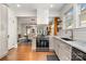 Bright and open kitchen with white cabinetry, granite counters, and stainless steel appliances overlooking dining room at 624 Oakland Ave, Charlotte, NC 28204