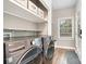 Convenient laundry room featuring modern washer, dryer, and shelving, near the entry at 624 Oakland Ave, Charlotte, NC 28204