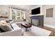 Spacious living room featuring hardwood floors, a fireplace, and large windows at 624 Oakland Ave, Charlotte, NC 28204