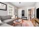 Cozy living room with a plush sofa, large windows, and warm-toned rug, perfect for relaxation at 624 Oakland Ave, Charlotte, NC 28204
