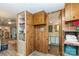 Hallway view of bathroom with storage cabinets, laminate floor, and colorful wallpaper at 6804 Lineberger Rd, Denver, NC 28037