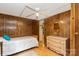 Bedroom with wood walls, a ceiling fan, and a dresser at 6804 Lineberger Rd, Denver, NC 28037