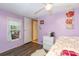 Bedroom featuring purple walls, white trim, and a bright window at 6804 Lineberger Rd, Denver, NC 28037