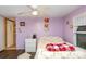 Bedroom with purple walls, white trim, and a white ceiling fan at 6804 Lineberger Rd, Denver, NC 28037