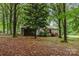 Charming single-story home with a screened porch, surrounded by mature trees and lush landscaping at 6804 Lineberger Rd, Denver, NC 28037