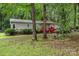 Exterior view of house with lush yard, green grass, and a driveway at 6804 Lineberger Rd, Denver, NC 28037