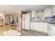 Well-lit kitchen with white cabinets and appliances connects seamlessly to a cozy breakfast area at 6804 Lineberger Rd, Denver, NC 28037