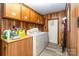 Well-lit laundry room with cabinetry, a washer, and a dryer at 6804 Lineberger Rd, Denver, NC 28037
