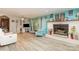 Cozy living room featuring a brick fireplace, light walls, and wood-look flooring at 6804 Lineberger Rd, Denver, NC 28037