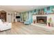 Cozy living room featuring a brick fireplace, light walls, and wood-look flooring at 6804 Lineberger Rd, Denver, NC 28037