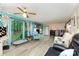 Spacious living room with large windows, laminate flooring, and a cozy fireplace at 6804 Lineberger Rd, Denver, NC 28037