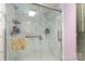 Spacious shower equipped with two shower heads and decorative marble wall design at 6804 Lineberger Rd, Denver, NC 28037