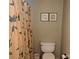Compact bathroom features a toilet, vanity, and patterned shower curtain, and neutral wall color at 711 4Th Sw Ave # B3, Conover, NC 28613