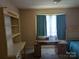 Bedroom with a desk, shelves, and blue curtains over the window at 711 4Th Sw Ave # B3, Conover, NC 28613