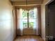 Bright dining area with wood floors, a large window, chandelier, and curtains at 711 4Th Sw Ave # B3, Conover, NC 28613