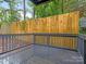 Outdoor deck overlooking a private backyard with lush greenery and tall trees at 716 Ellsworth Rd, Charlotte, NC 28211