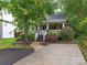 Beautifully landscaped home with a cozy front porch, offering a blend of charm and curb appeal at 716 Ellsworth Rd, Charlotte, NC 28211