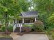 Charming home featuring a welcoming porch, manicured landscaping, and a blend of natural beauty and curb appeal at 716 Ellsworth Rd, Charlotte, NC 28211