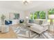Airy living room with ample seating, bright decor and natural light flowing in through a large window at 716 Ellsworth Rd, Charlotte, NC 28211