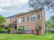 Backyard view features a brick home and fenced yard, perfect for outdoor enjoyment at 7722 Springs Village Ln # 40, Charlotte, NC 28226