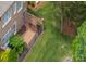 Aerial view of fenced backyard, brick patio, and mature landscaping at 7722 Springs Village Ln # 40, Charlotte, NC 28226