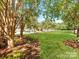 A beautiful, landscaped street view shows a well-maintained neighborhood at 7722 Springs Village Ln # 40, Charlotte, NC 28226