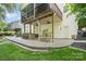 The brick patio features a built-in bar, porch swing, and access to the upper screened porch at 7730 Windsor Forest Pl, Harrisburg, NC 28075