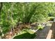 An elevated view of the backyard features wooden steps leading down to the firepit patio at 7730 Windsor Forest Pl, Harrisburg, NC 28075