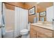 Well-lit bathroom with a shower-tub combo, vanity, and neutral color scheme at 7730 Windsor Forest Pl, Harrisburg, NC 28075