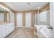 Spacious bathroom featuring dual sinks, a glass-enclosed shower, and a soaking tub at 7730 Windsor Forest Pl, Harrisburg, NC 28075