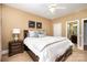 Bright bedroom with a queen-size bed, matching nightstand, and adjacent bathroom entrance at 7730 Windsor Forest Pl, Harrisburg, NC 28075