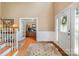 Spacious foyer with a white front door with decorative glass and hardwood floors leading to other rooms at 7730 Windsor Forest Pl, Harrisburg, NC 28075