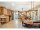 Spacious kitchen with custom cabinets, stainless steel appliances, tile backsplash, and a cozy dining area at 7730 Windsor Forest Pl, Harrisburg, NC 28075
