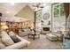 Spacious living room with high ceilings, a stone fireplace, large windows, and open access to the kitchen at 7730 Windsor Forest Pl, Harrisburg, NC 28075