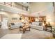 Open-concept living room featuring a staircase, with hardwood floors and view into the kitchen area at 7730 Windsor Forest Pl, Harrisburg, NC 28075