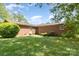 Well-maintained backyard with green grass and brick home exterior, a serene outdoor retreat at 812 Clinton Ave, Lancaster, SC 29720