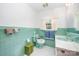 Vintage bathroom featuring tiled walls, fixtures in matching mint green, and ample lighting at 812 Clinton Ave, Lancaster, SC 29720