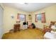 Bright bedroom with yellow walls, two windows and an inviting rocking chair at 812 Clinton Ave, Lancaster, SC 29720