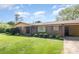 Charming brick home featuring a well-manicured lawn and covered carport at 812 Clinton Ave, Lancaster, SC 29720