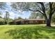 Charming brick home featuring a well-manicured lawn and covered carport at 812 Clinton Ave, Lancaster, SC 29720
