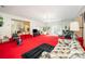 Large living room featuring red carpeting and a sliding glass door to another living space at 812 Clinton Ave, Lancaster, SC 29720